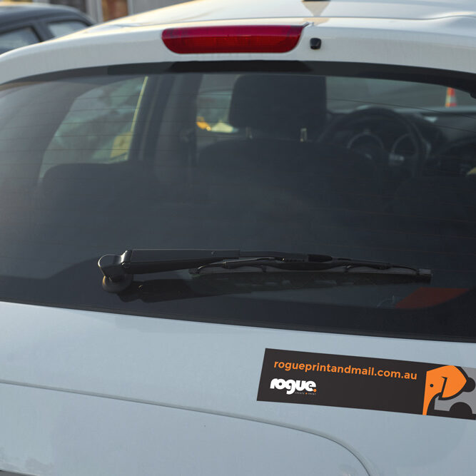 Bumper Sticker With Rogue Print And Mail On The Boot Of A Car